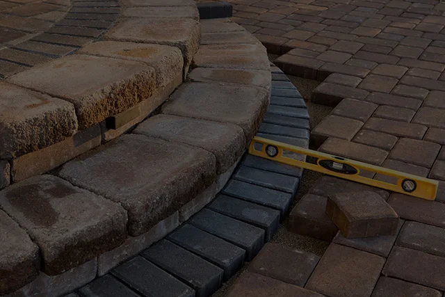 A brick walkway with steps and a level.