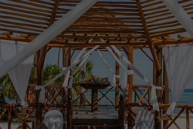 A wooden structure with chairs and a view of the ocean.