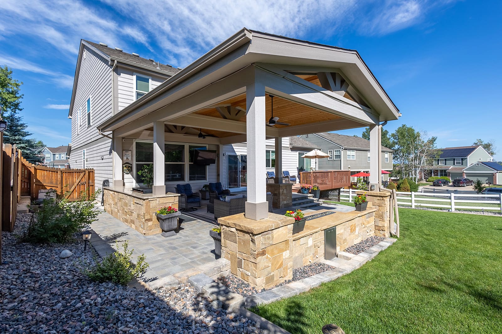 A patio with a stone wall and pillars