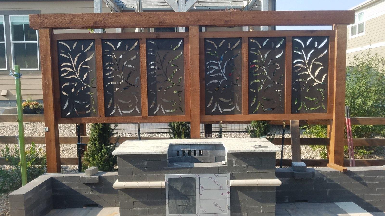 Outdoor kitchen with decorative screen.