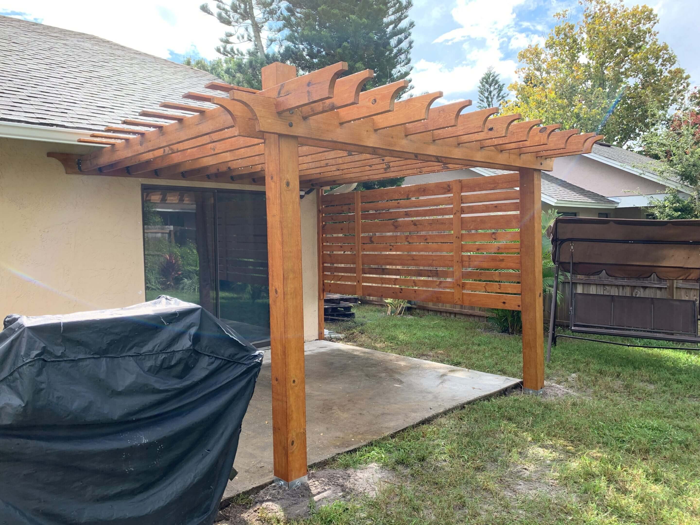 Wooden pergola with privacy screen.