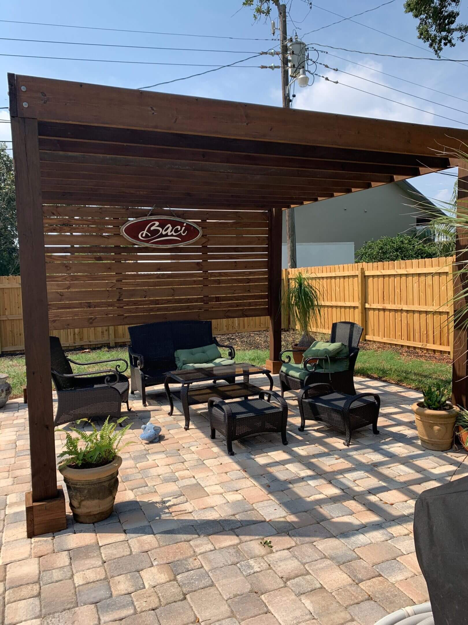 Wooden pergola with patio furniture.