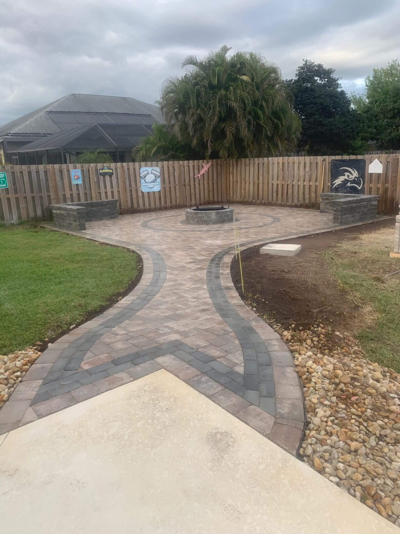 Here's an alt tag for the image: Brick paver patio with fire pit.