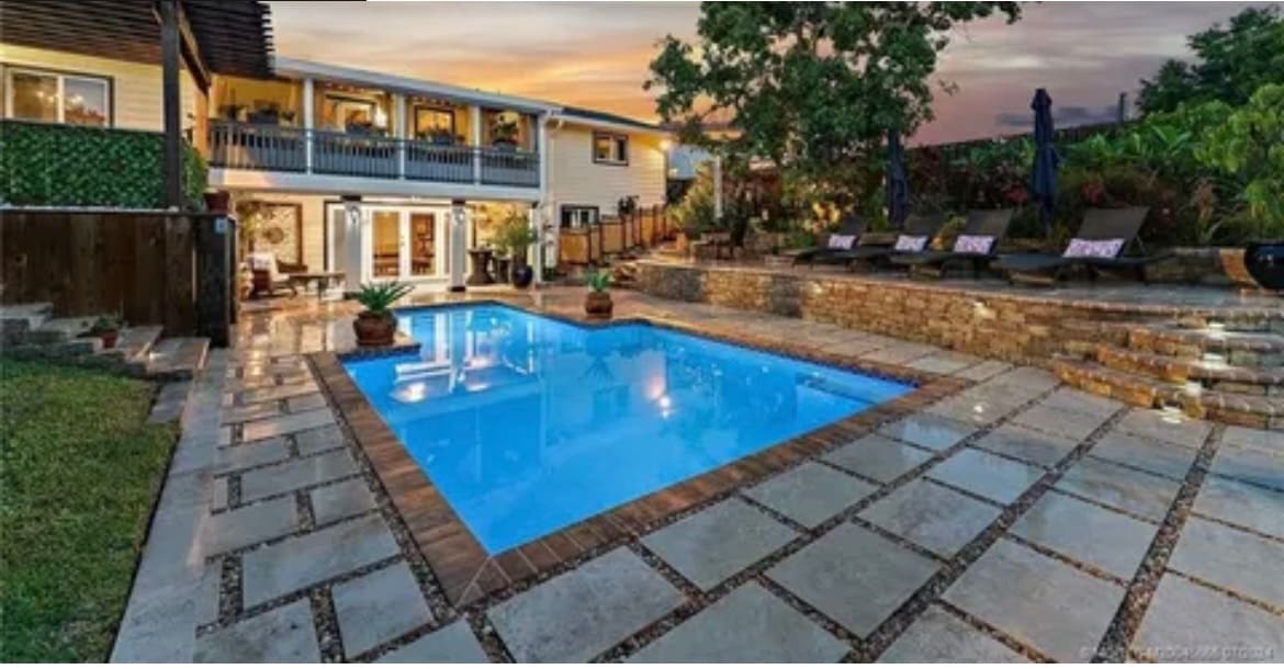 House with blue pool and patio.