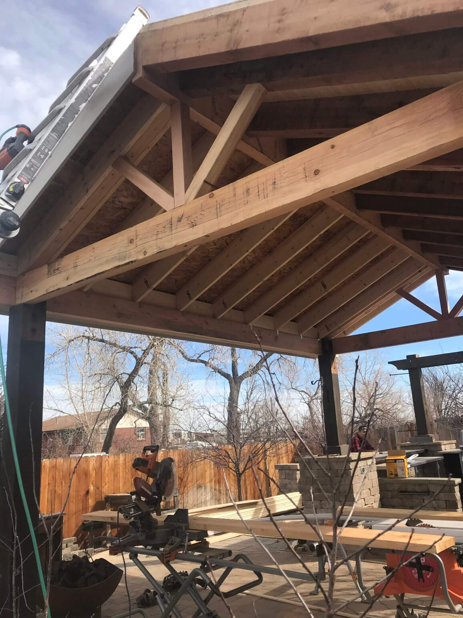 Wooden pergola under construction outdoors.
