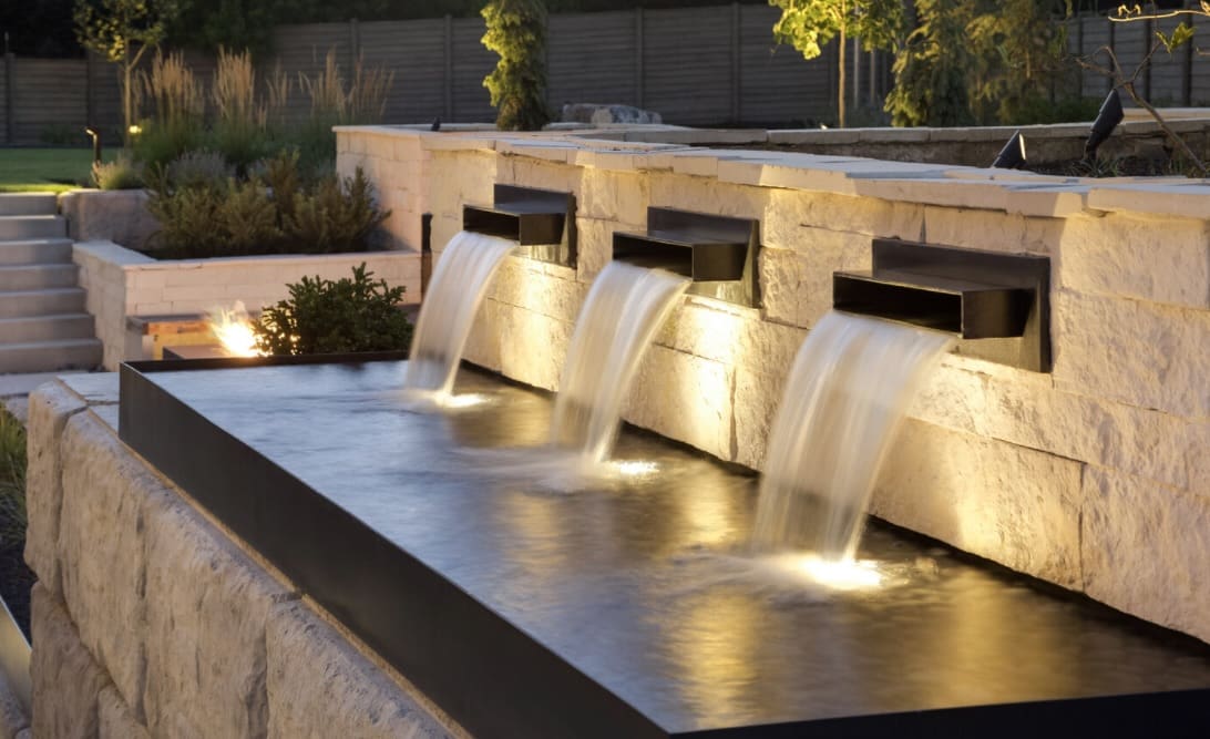 Modern stone water feature with three streams.